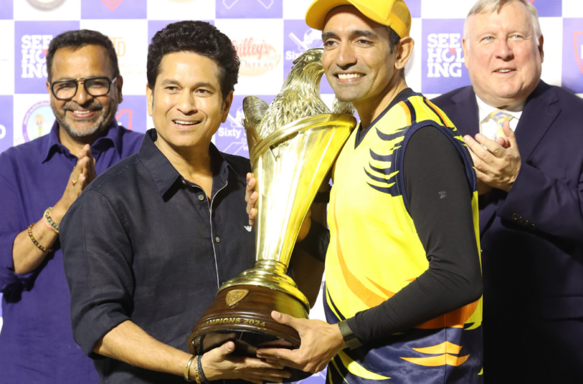 Robin Uthappa, captain of NCL champions Chicago Cricket Club, receiving the trophy from Sachin Tendulkar.